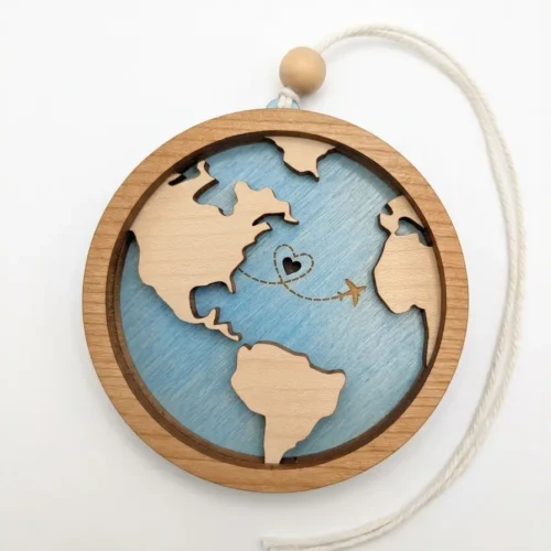 Engraved maple wood travel globe and airplane ornament by Foxwood Gifts hanging by twine