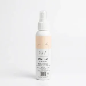 Spraying a natural aloe and lavender after sun mist onto sun-exposed skin