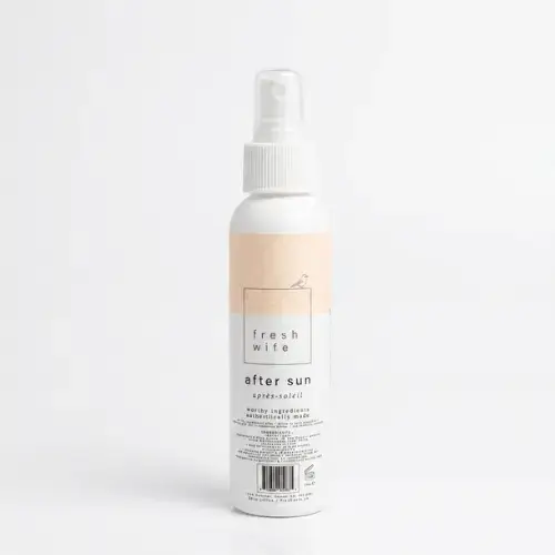 Spraying a natural aloe and lavender after sun mist onto sun-exposed skin