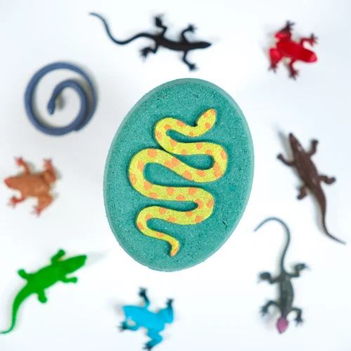Kids surprise bath bomb fizzing green and blue in a tub to reveal a hidden jungle toy