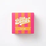Box of Happy Hippo Bath Co Self Care Cube Bombs featuring yellow and pink cubes