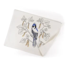 Unfolded Porchlight Press Blue Jay tea towel showing the detailed blue bird and oak leaf illustration