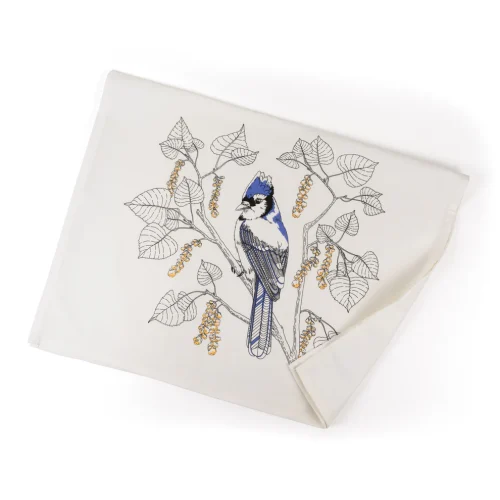 Unfolded Porchlight Press Blue Jay tea towel showing the detailed blue bird and oak leaf illustration