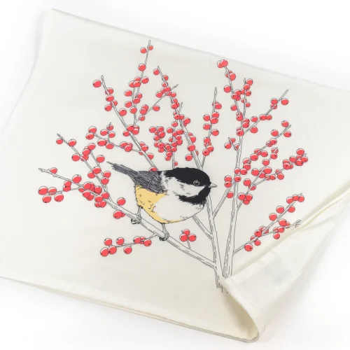 Absorbent chickadee flour sack cotton kitchen towel hanging neatly on a modern oven handle