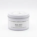 Lit natural coconut wax bug repellent candle burning cleanly on an outdoor patio table