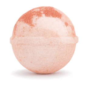 Shimmering orange and vanilla cocktail bomb fizzing in sparkling water with edible glitter