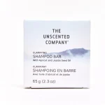 Solid round The Unscented Co Shampoo Bar in plastic-free paper packaging