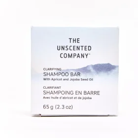 Solid round The Unscented Co Shampoo Bar in plastic-free paper packaging