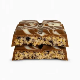 Close-up of a broken Astro Snacks Cookies &amp; Cream Dubai Chocolate Bar showing the cream and cookie filling against a pure white background
