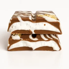 Close-up of a broken Astro Snacks Cookies & Cream Dubai Chocolate Bar showing the cream and cookie filling against a pure white background