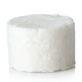 Unpackaged solid dish soap refill cake resting