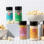 Klondike Kettle Corn Gourmet Popcorn Seasoning shakers in flavor varieties on a counter