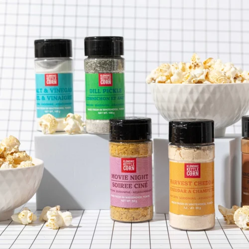 Klondike Kettle Corn Gourmet Popcorn Seasoning shakers in flavor varieties on a counter