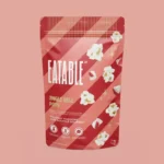 Jingle Bell Pops white chocolate Christmas popcorn by EATABLE, peppermint infused with candy cane crystals, 125 g bag, made in Canada